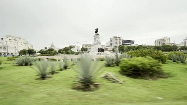 Tracking shot of Monument Maximo Gomez in Havana old city center in front of Malecon street
