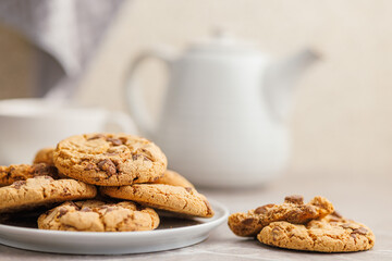 Sweet chocolate cookies on plate on kitchen table.