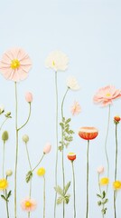 Colorful paper flowers in full bloom arranged vertically on a blue backdrop
