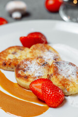 Sweet delicious food for breakfast. Pancake cheesecakes with fresh strawberry, blueberry and maple syrup. Delicious tasty pancake, morning food in cafe. 
