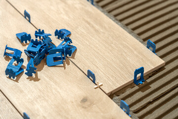 Repair and construction. Laying ceramic tiles using cement on the floor close-up. A man lays slabs on the floor and walls.