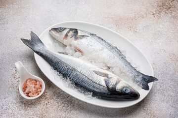 Fresh raw sea bass on a plate. Close up