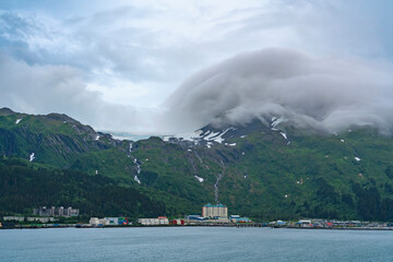 Fototapeta na wymiar landscape view of Whittier town in Alaska and surrounding snow capped mountain in cloud
