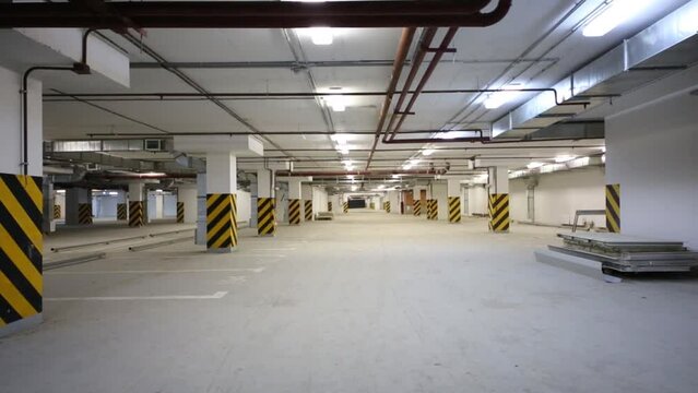 Spacious well-lit underground car park with free parking spaces