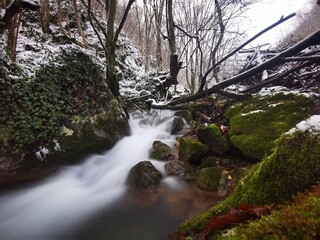 Mountain stream in winter. Ice and snow on a beautiful mountain creek
