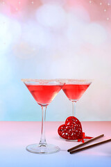 Festive alcoholic cocktail red martini in glasses and love hearts, bar concept and valentine's day, alcoholic drinks at party, restaurant advertisin