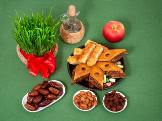 The vernal equinox, a traditional table on Navruz. wheat grass, Arabic baklava dessert, sweets, nuts, dried fruits