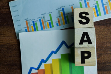 Concept of The wooden Cubes with the word SAP - Systems Applications Products on wooden background.