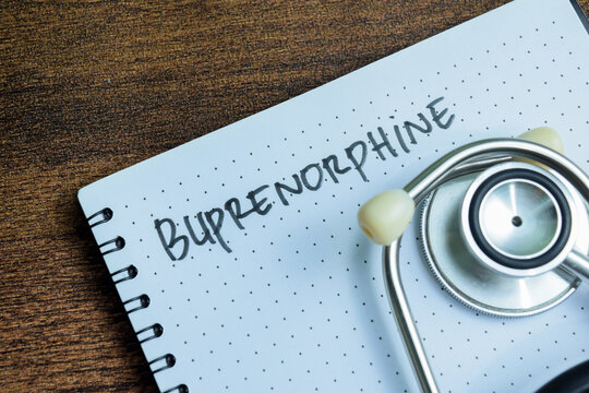 Concept of Buprenorphine write on book with stethoscope isolated on Wooden Table.