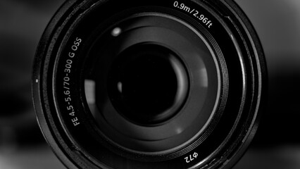 Macro photo of a 70-300mm Camera Lens with a dark motif and subtle light reflections