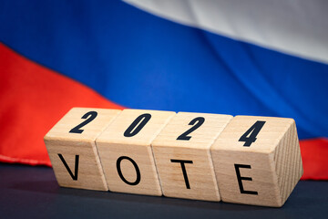 Russia vote 2024, Wooden blocks written vote 2024, Russian flag in the background. Concept of...