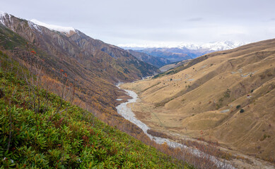 Elevated View of a Meandering River in the Valley. From a high vantage point, the river snakes...