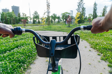 View of bicycle handle bar againts nature path park. Concept of Healthy lifestyle, leisure activity and mode of transport