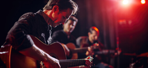 Obraz premium Guitarist playing guitar performing at a colourful concert, close up