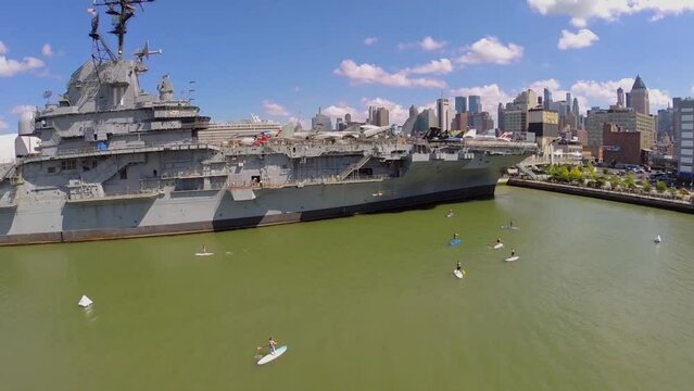 Many people surf on boards near Sea-Air-Space museum