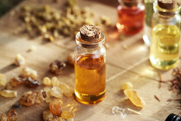 Obraz na płótnie Canvas A bottle of frankincense essential oil with boswellia resin