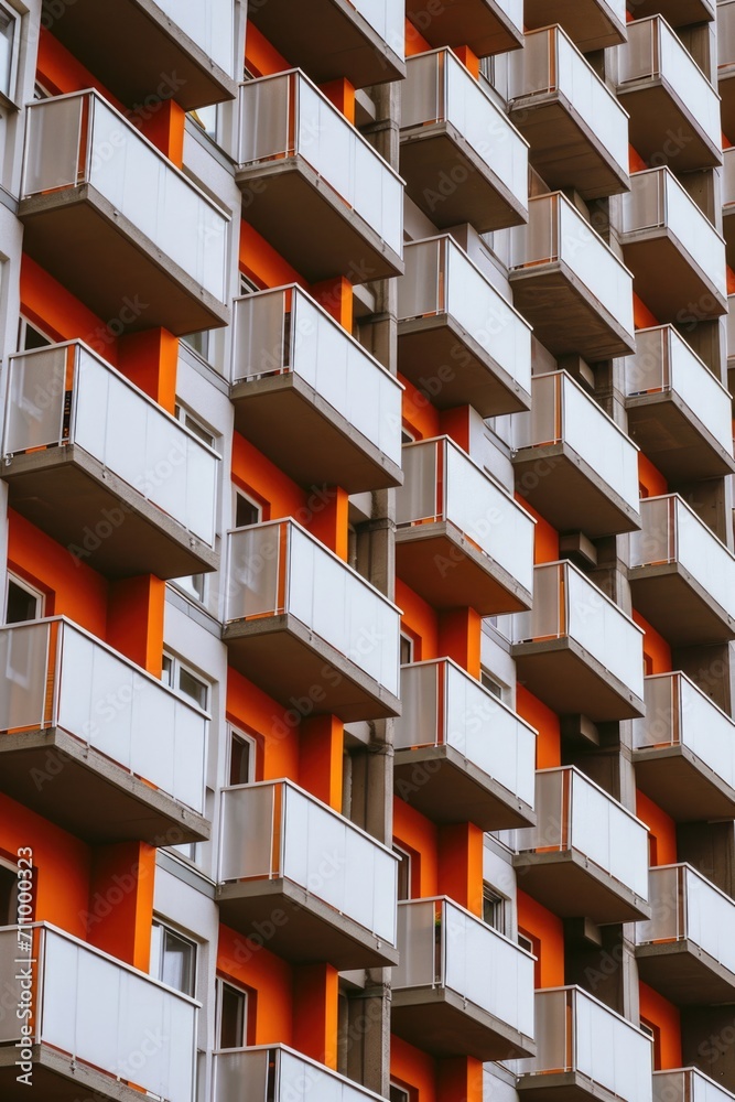 Poster a contemporary orange and white building with multiple balconies. perfect for architectural and real