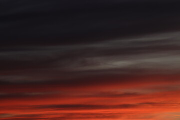 A breathtaking sunset sky painted with a palette of deep reds and oranges, a dramatic backdrop that evokes a sense of calm and wonder.