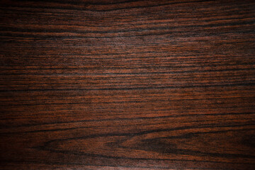 Photo of the texture of a dark mahogany countertop.Wooden background for the text.