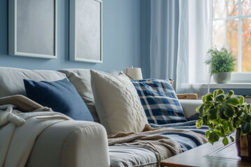 A close-up of a cozy couch with blue and white pillows in a room with light blue walls, suggesting a tranquil domestic setting. The image is suited for home lifestyle content.