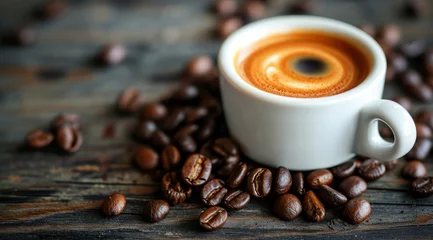 Fotobehang Cup of breakfast coffee with beans lying on a rustic table © Eliya