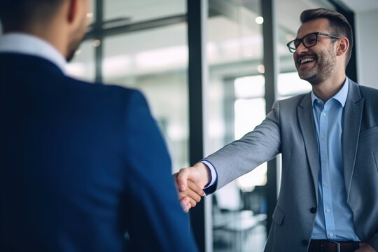 Two businessmen shaking hands in an office