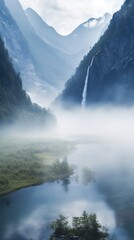 Misty mountain valley with waterfall and lake