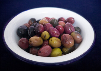 Ceramic bowl filled with cut pickled olives