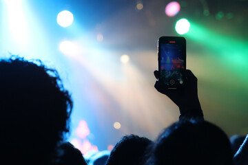a phone taking a video in a music concert