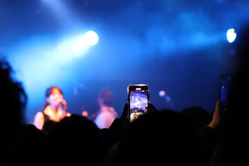 a phone taking a video in a music concert