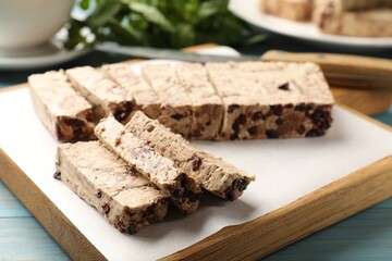 Pieces of tasty chocolate halva on table, closeup