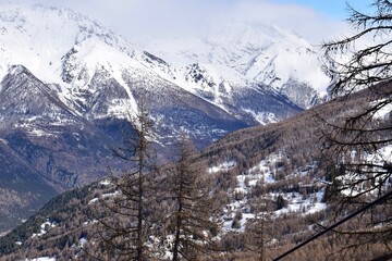 Fototapeta na wymiar Stunning view from Sauze D'Oulx ski resort, Turin, Italy. Beautiful Italian alpine peaks of snow capped mountains in the Piedmont region.