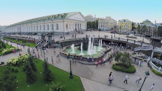 Tourists walk near fountain on Manezhnaya square 