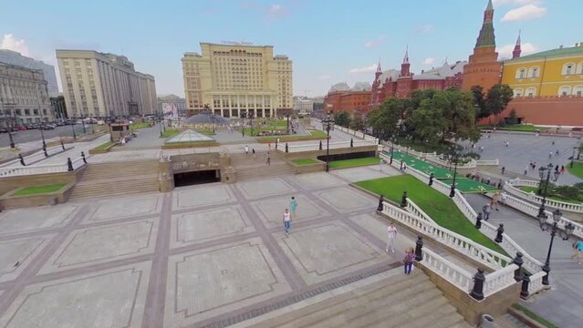 People walk by Manezhnaya square near hotel Moskva 