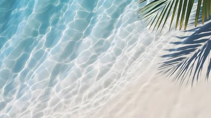Fotobehang top view of water surface with tropical leaf shadow. Shadow of palm leaves on white sand beach. Beautiful abstract background concept banner for summer vacation at the beach.  © Ziyan Yang