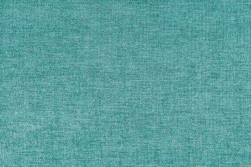 Textile background, turquoise coarse fabric texture, cloth structure close up, jacquard woven upholstery, furniture textile material, wallpaper, backdrop..