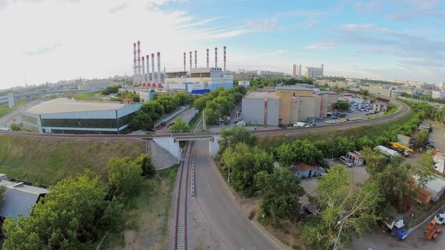 City industrial zone with road and railway at summer day. 