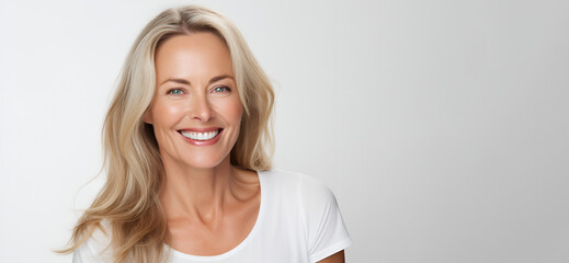 Beautiful middle-aged woman on a gray background. - Powered by Adobe