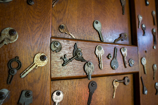 wooden door with different iron keys
