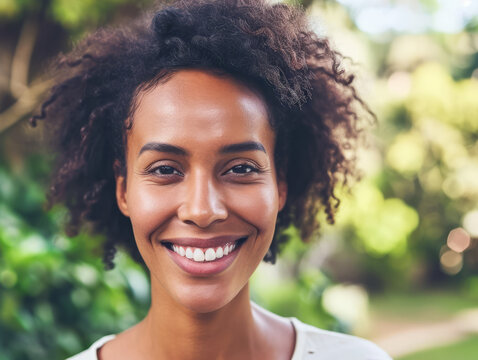 Portrait of a beautiful young african american woman smiling outdoors