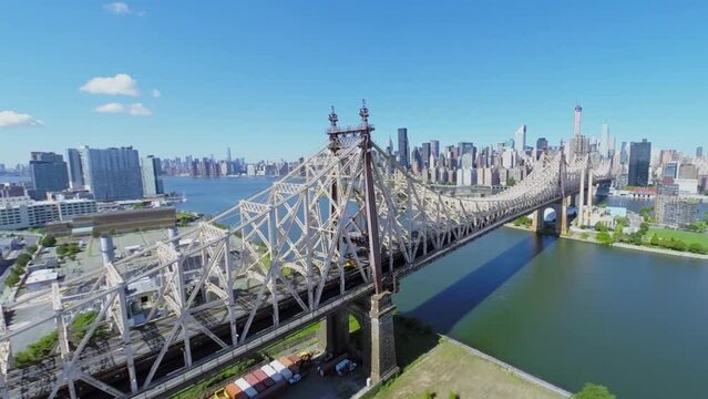 Cityscape with traffic on Queensboro Bridge over East River at summer