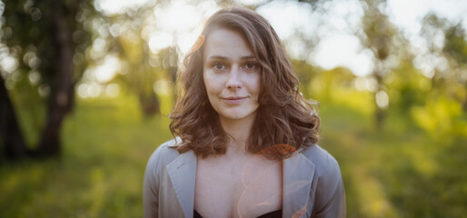 beautiful woman 30 years old in the summer in a sunny park, portrait with shallow depth of field of a  beauty