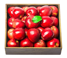 ripe red apples in a wooden box