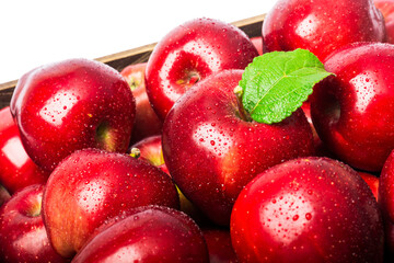 Red apples with green leaf and water drops