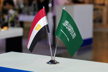 Two small table flags of Egypt and Saudi Arabia together at some event or fair, as a symbol of...