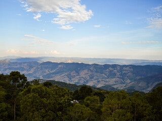 Panoramic View of Rolling Hills and Lush Greenery Under a Clear Sky