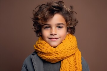 Portrait of a cute little boy in warm clothes and scarf.