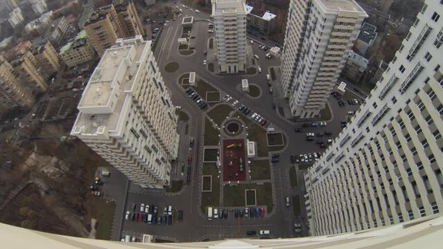 Parking between modern buildings at day, top view. Time lapse.