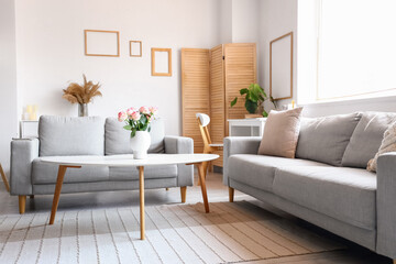 Interior of light living room with sofas and table