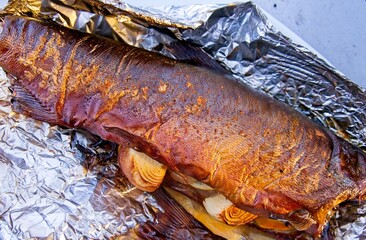 Whole salmon smoked and grilled with onion and lemon